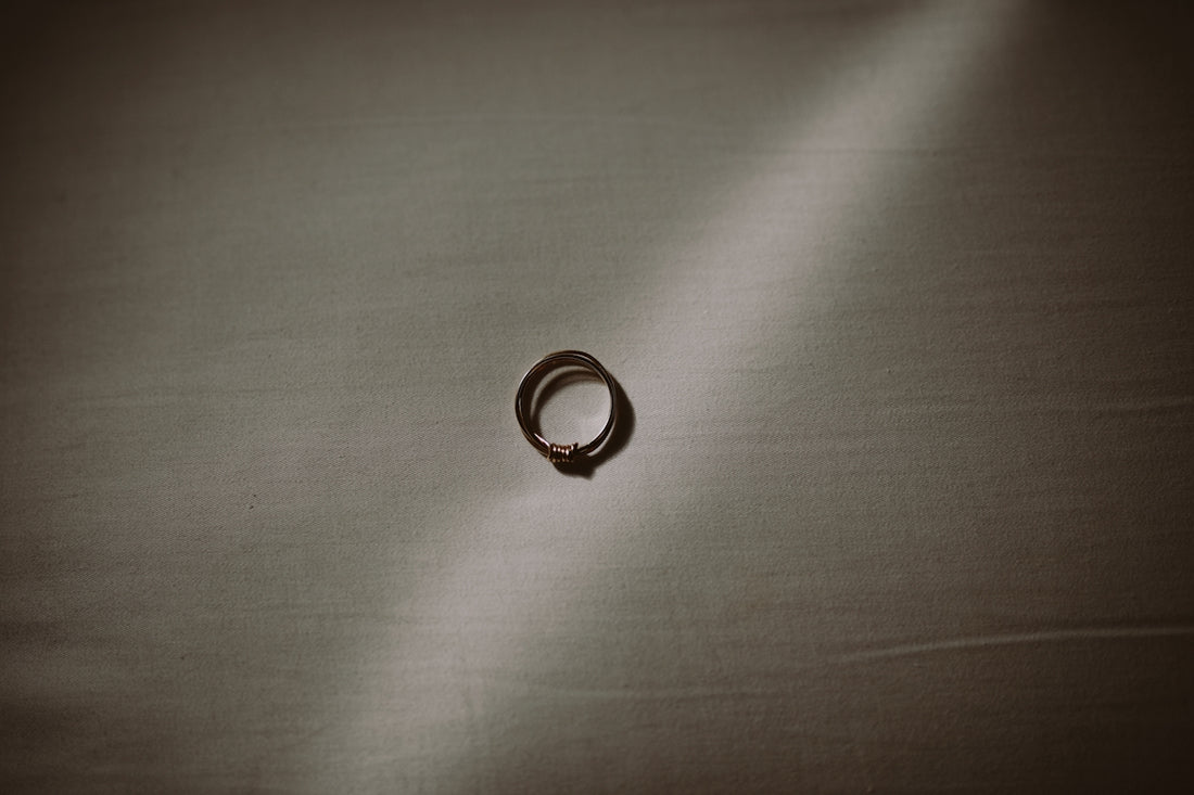 silver ring on gray textile