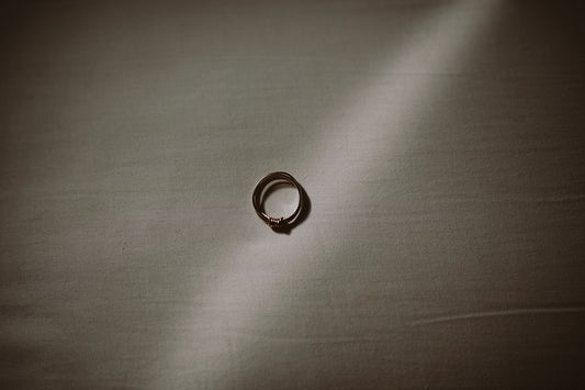 silver ring on gray textile