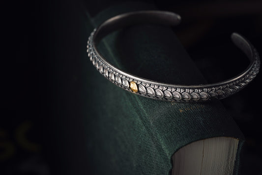 a close up of a book with a bracelet on it