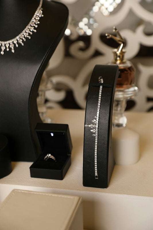 Jewelry display featuring diamonds, rings, and a necklace.